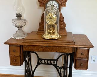 Singer sewing machine table and antique clocks
