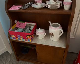 Doll hutch with childs' tea sets