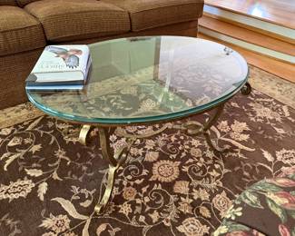 glass & brass oval coffee table; area rug