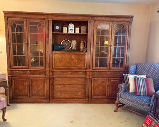 Beautiful three-piece Thomasville wall hutch with middle secretary desk. Blue and pink wingback chairs.
