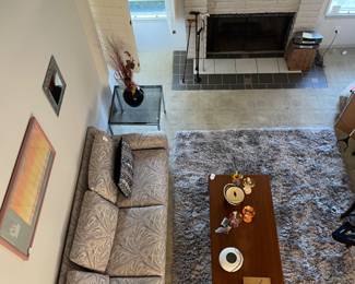 View from loft area of this great home shows Jack Schultz art, reupholstered 7' Mid-Century couch, teak coffee table and other cool smalls...