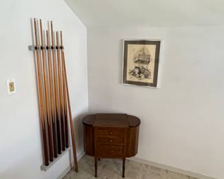 The oak piece in the corner is an antique sewing box. The pool cues along with the pool table are 1970's & 80's vintage.