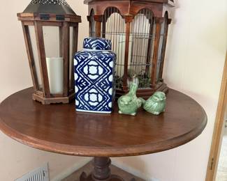 Rustic Decorative Lantern, Blue/White Lidded Jar with Trellis Design, Pair of Green Ceramic Bird Figurines, Wooden Dome Birdcage, Round Pedestal Table