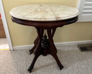 R14 - $225 - Victorian Walnut side table w/ oval marble top. Measuring 29W x 21D x 30T