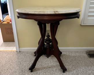 R14 - $225 - Victorian Walnut side table w/ oval marble top. Measuring 29W x 21D x 30T