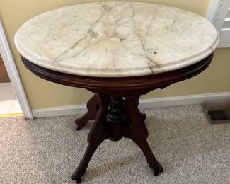 R14 - $225 - Victorian Walnut side table w/ oval marble top. Measuring 29W x 21D x 30T