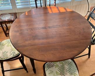 R20 - $125 - Round Wood Drop Leaf Dining Table. Chairs not included. The table is in great condition! With natural wood finish on top and black painted legs. Measures 42" round and 26"W when dropped.
