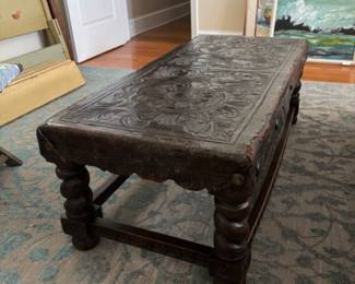 Elizabethan embossed leather bench as cocktail table