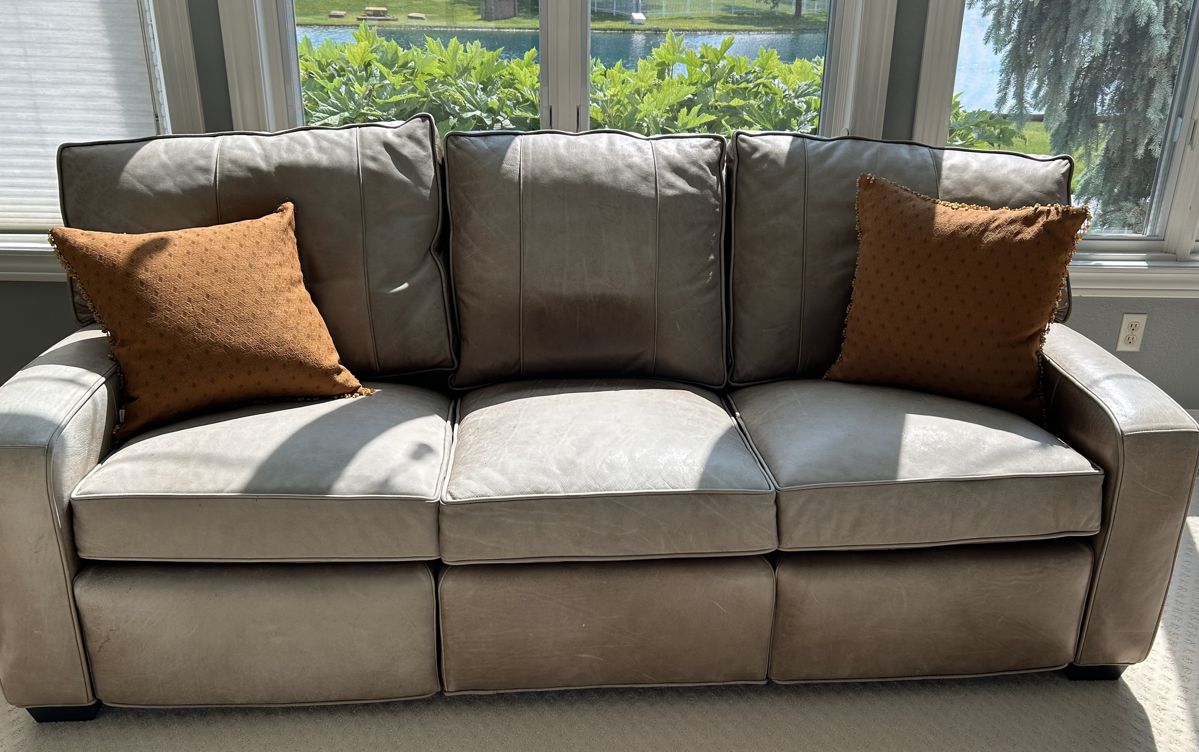 Arhaus leather couch with left and right retractable foot stool