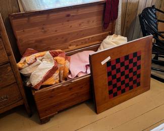 cedar chest, quilt and blanket, large checkerboard used on a wheelchair