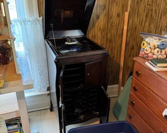 Full view of RCA victrola, small chest of drawers, many craft magazines