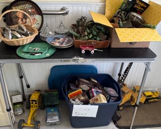 boxes of green wood handled kitchen utensils, Tonka Toys, lots of small Hershey trucks