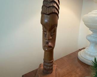 “Ritual in Wood" Mid-Century African Wood Bust, typically used in religious rituals and ceremonies. These busts often feature finely carved rings around the neck, symbolizing social status, wisdom, or spiritual elevation. The intricate details and textures of the wood give the sculptures a ritualistic feel.