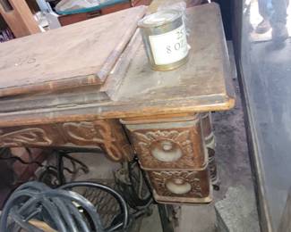 A Singer Sewing machine in the cabinet.