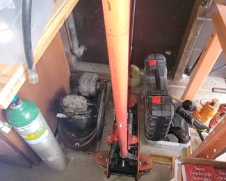 Various Jacks, tools and an old air compressor.