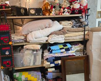 Vintage clock / radios, quilts, blankets, mirror.
