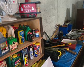 Tables and tables of tools! Birdhouse, fan, yard and garage sprays/chemicals/fertilizers.