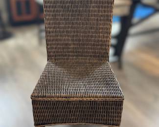 One of four wicker woven dining chairs