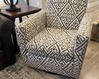 One of two cozy swivel arm chairs