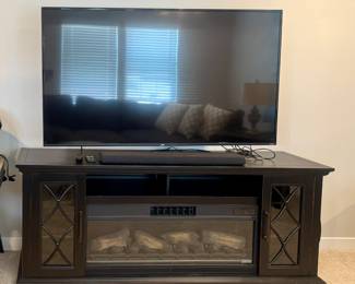 TCL large flat screen an Trevanti fireplace stand