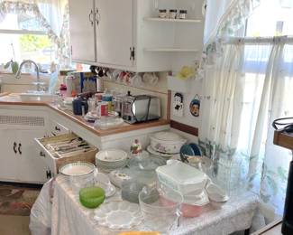 The kitchen also features several dishes, bakeware, and appliances, not to be missed.