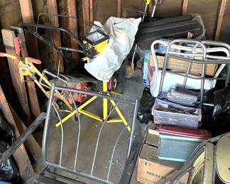 In the garage, there is a stand-mounted work light, a powered edger, a lawn mower, and more treasures to find.