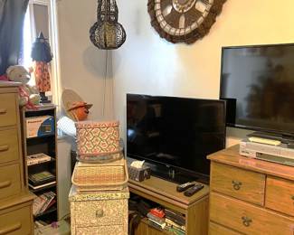 There is a second monitor on the low cabinet, plus an interesting wall hanging.
