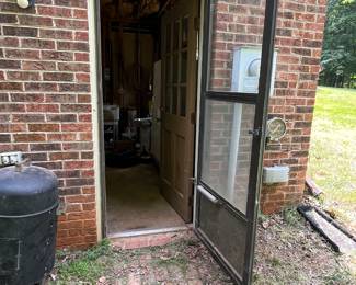 Side entrance to basement room full of tools and Etc