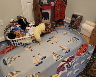 Area rug (New), quilt rack, stuffed animals
