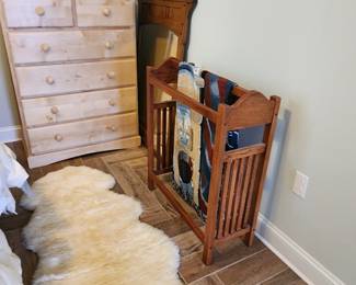 quilt rack, animal skin rug, chest of drawers