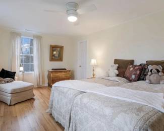 Twin beds - lamps, side tables, cedar chest.