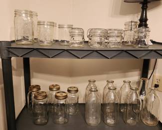 Serv-all milk bottles from Toledo, more milk bottles, Vintage Anchor Hocking, Atlas, Ball, and Kerr canning jars from various decades, some with lids, some wide-mouth