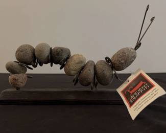 Rock Caterpillar on Wood Stand by Ancient Graffiti