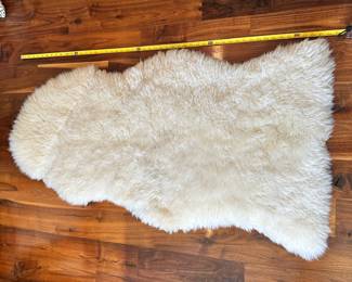 M74 - $60. Safavieh Sheep Skin White. Measures 2' x 4'.