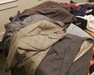 Many mens clothing items, from sport coats to shirts, shorts and some shoes.