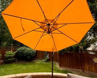 Outdoor patio includes Crate & Barrel Wicker Patio Set and Copper Weber Grill with a Crate & Barrel Cantilever Umbrella