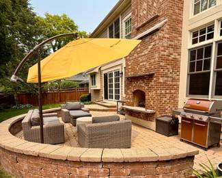 Outdoor patio includes Crate & Barrel Wicker Patio Set and Copper Weber Grill with a Crate & Barrel Cantilever Umbrella