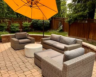 Outdoor patio includes Crate & Barrel Wicker Patio Set and Copper Weber Grill with a Crate & Barrel Cantilever Umbrella