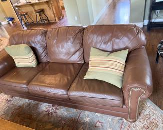 Leather sofa and loveseat with brads