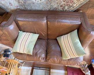 Leather sofa and loveseat with brads