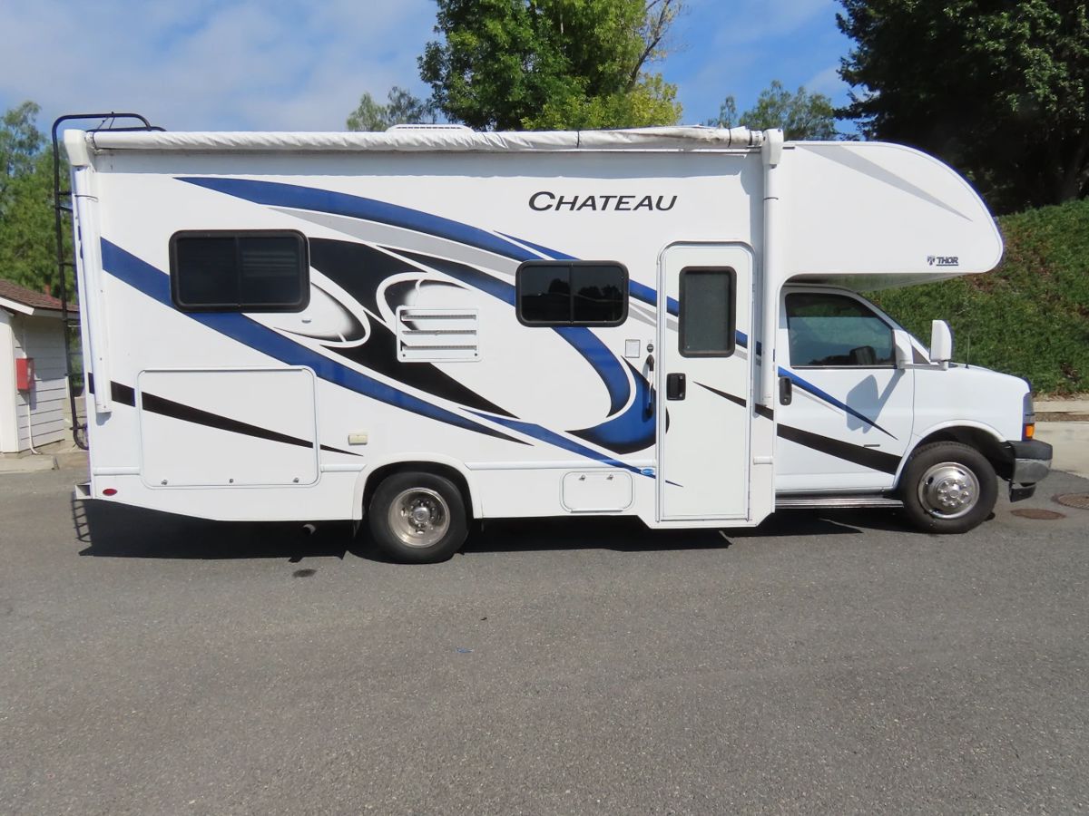 RV Motorhome. THOR CHATEAU 22E. 2021 model year, mileage 22,030. Sleeps 6, excellent condition many extras. Full bathroom, two queen beds, solar panels, microwave, propane stove and fridge, two zone AC and heating. VIN 1HA3GSCGOKN014902.
