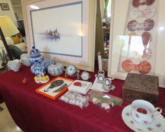 Brighton clocks, blue and white ceramics, framed sea shells.