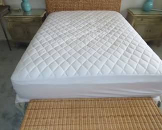 Full size bed with sea grass headboard and wicker bed bench.