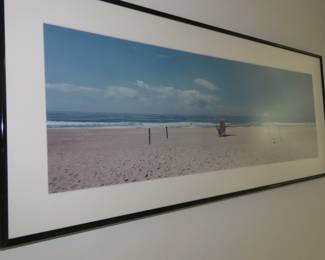 Framed beach scene photograph.