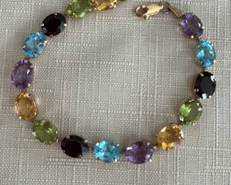 14k yellow gold with large amethyst, blue topaz, garnet and citrine stones. Beautiful!