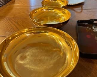 Three footed, polished brass bowls
