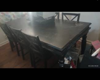 Long black shabby chic, farmhouse, harvest table with carved trim. Chunky legs. 6 chairs