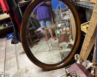 Large oval wood framed beveled mirror