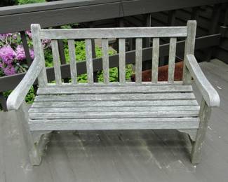 Teak bench has cushions