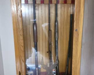 Oak gun cabinet. Below the glass display, there's a solid wooden drawer with a key, for more secure storage area.